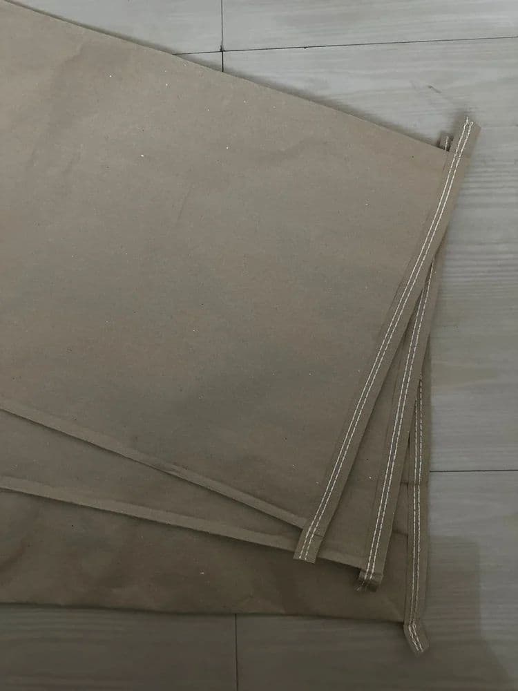 Layered paper bag material and stitched construction detail